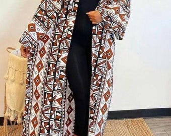May include: A long white and brown patterned kimono with a geometric design. The kimono has long sleeves and a wide open front.