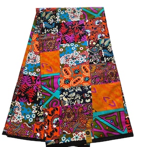May include: A vibrant patchwork fabric featuring a variety of colorful patterns. The design includes floral, paisley, and geometric motifs in shades of orange, blue, purple, and green. The fabric is folded, showcasing the diverse patterns.