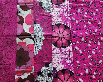 May include: A vibrant textile featuring a patchwork of patterns in shades of pink, white, and black. The designs include floral motifs, abstract shapes, and a textured background, creating a visually rich and colorful fabric.