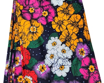 May include: A colourful fabric with a floral pattern. The fabric features large, vibrant flowers in shades of pink, yellow, white, and red on a dark blue background. The flowers are surrounded by green leaves and small white dots.