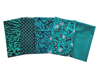 May include: Five fabric pieces in shades of teal and black. Patterns include animal print, scales, tree branches, floral designs, and a solid teal piece. The fabrics are arranged side by side, showcasing the variety of designs.