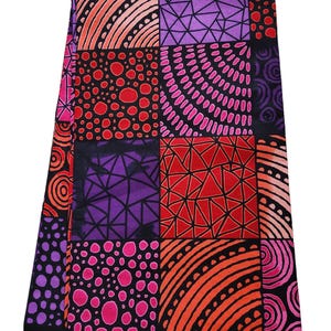 May include: A colorful fabric with a patchwork design featuring geometric shapes, circles, and dots in shades of pink, red, orange, purple, and black. The fabric has a "GUARANTEED PRINTED" label.