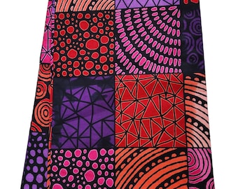 May include: A colorful fabric with a patchwork design featuring geometric shapes, circles, and dots in shades of pink, red, orange, purple, and black. The fabric has a "GUARANTEED PRINTED" label.