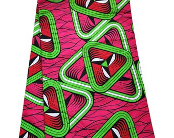 May include: Pink fabric with a repeating pattern of green, white, and red triangles. The fabric has a woven texture and is suitable for sewing projects.