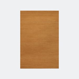 May include: A rectangular, golden-brown rug with a ribbed texture. The rug's surface is covered in horizontal lines, creating a textured appearance. The rug is a solid color and appears to be made of a soft material.