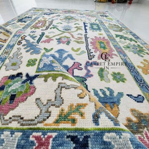 Pastel Turkish Oushak Rug: Handwoven Wool, Cream Pink Blue Floral.