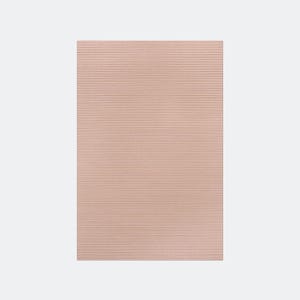 May include: A rectangular, blush-colored rug with a ribbed texture. The rug's surface is covered in horizontal lines, creating a subtle pattern. The rug is a solid color and appears to be made of a soft material.