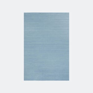May include: A rectangular, light blue rug with a textured, ribbed surface. The rug's design features horizontal lines, creating a subtle pattern. The color is a soft, muted blue, suitable for various interior design styles.