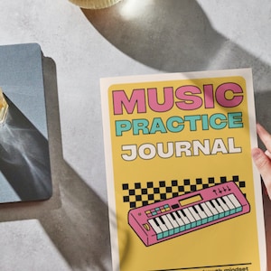 May include: A music practice journal with a yellow cover featuring the text MUSIC PRACTICE JOURNAL in pink and blue, a graphic of a pink synthesiser, a black and white checkered pattern, and the text habit tracker - goals - growth mindset.
