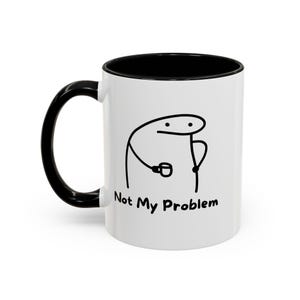 May include: A white ceramic mug with a black interior and a black handle. The exterior features a black line drawing of a simple stick figure character holding a small cup, accompanied by the printed black text that reads Not My Problem.