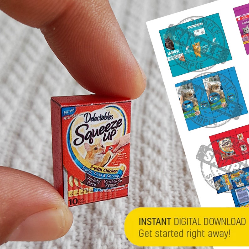 Pode incluir: Uma caixa em miniatura de comida para gatos Delectables Squeeze Up em uma caixa vermelha e branca com um gato na frente. A caixa diz "Nova f&oacute;rmula" e "5-com frango e camar&atilde;o".