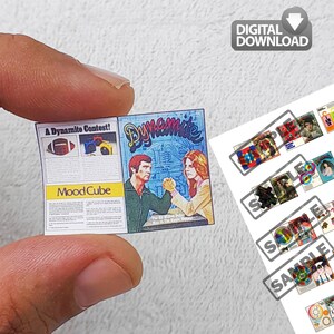 May include: Miniature magazine with the word "Dynamite" and a retro illustration of a man and woman arm wrestling. The magazine also features the text "A Dynamite Contest!" and "Mood Cube". A "Digital Download" icon is in the upper right.