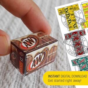 May include: A miniature cardboard box of A&W Root Beer, featuring the iconic A&W logo and a wooden barrel design. The box is labelled "12 CANS" and "ROOT BEER SINCE 1919".