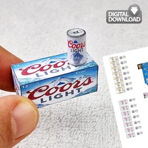 May include: Miniature Coors Light beer can and 12-pack box. The can is white with red lettering and a mountain graphic. The box is blue and white with red lettering. The words "DIGITAL DOWNLOAD" are in the upper right corner.