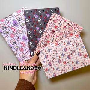 Puede incluir: Cuatro insertos rectangulares para Kindle y Kobo con varios patrones. Uno es lavanda con sellos, castillos y murciélagos. Otro es gris con calaveras, cuchillos y lápiz labial. Un tercero es rosa con sellos y llaves. El último es rosa y blanco a rayas con gansos de dibujos animados.