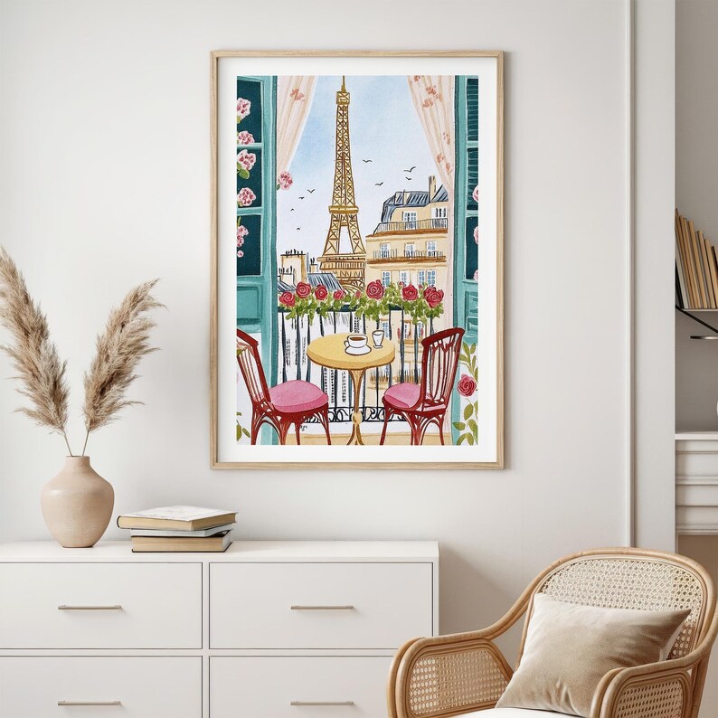 May include: Watercolor painting of a Parisian balcony scene. The Eiffel Tower is visible through the window. A small round table with two chairs, a cup and a saucer are on the balcony. Red roses and pink cushions add color to the scene.