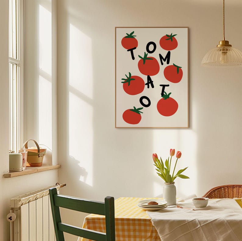 May include: A white framed print with a red and green illustration of tomatoes and the word "TOMATO" in black letters.
