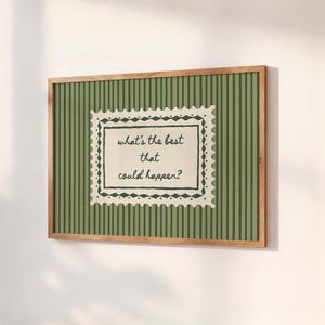 May include: A rectangular wall art print in a light wood frame featuring a dark green and olive green vertical striped background. A central cream-coloured stamp-shaped graphic contains the dark green text: what's the best that could happen?