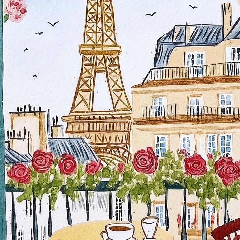 May include: Watercolor painting of a Parisian scene featuring the Eiffel Tower, buildings, and red roses. A table with coffee cups is in the foreground. The artwork has a soft, artistic style with a focus on the iconic landmarks and floral elements.
