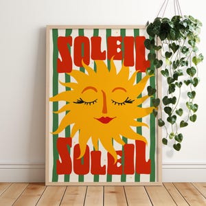 May include: A retro-style poster featuring a yellow sun with a smiling face and closed eyes. The sun is surrounded by green and white stripes and the word "SOLEIL" is written in red letters above and below the sun.