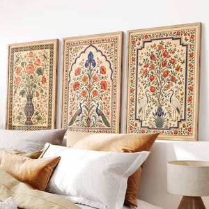 May include: Three rectangular framed wall art prints featuring intricate botanical and animal illustrations. The left print shows a floral vase, the center displays peacocks with poppies, and the right depicts cranes under a pomegranate tree.