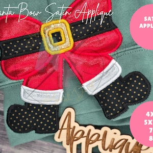 May include: Red and white Santa bow applique with black polka dots and a gold buckle. The applique is on a green sweatshirt with the text "SATIN APPLIQUE" and "4x4 5x7" 7" 8" printed on a pink circle.