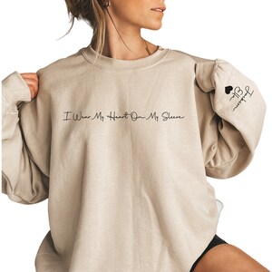 I Wear My Heart On My Sleeve Sweatshirt, Mothers Day Shirt, Mama Sweatshirt with Kids Name on Sleeve, Personalized Mother Day Gift for Mom