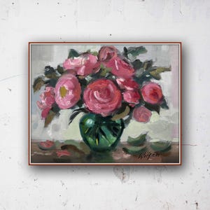 May include: An oil painting depicting a bouquet of pink roses in a green vase. The roses are in full bloom, with a mix of light and dark pink petals. The vase is a deep green colour, and the background is a soft, neutral tone. The painting is framed in a brown wooden frame.