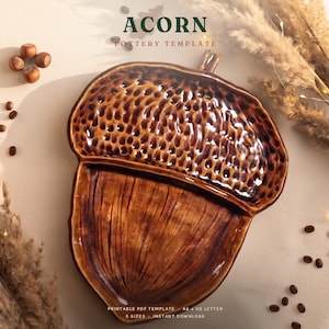 May include: A brown ceramic acorn-shaped dish featuring a textured cap with a dimpled pattern and a smooth, vertically lined base. The text ACORN POTTERY TEMPLATE is visible at the top, with PRINTABLE PDF TEMPLATE 3 SIZES INSTANT DOWNLOAD below.
