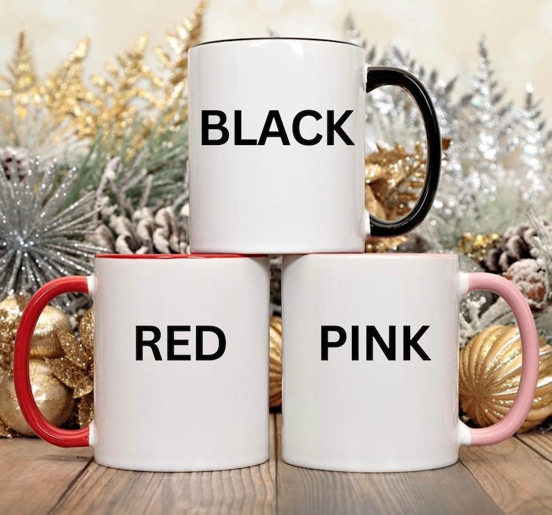 May include: Three ceramic mugs with black handles. The mugs are white with black lettering. The mugs say "BLACK", "RED", and "PINK".