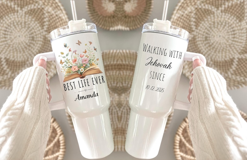 May include: Two white insulated tumblers with handles and straws. One features the text "BEST LIFE EVER" with floral and butterfly graphics, and the name "Amanda." The other says "WALKING WITH Jehovah SINCE 10.12.2025."