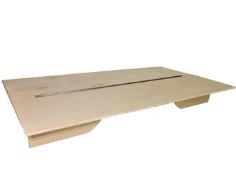 May include: A light wood platform bed frame with a metal hinge running down the center. The frame has two small, curved supports on each side.