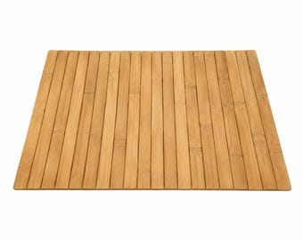 May include: A rectangular mat constructed from numerous thin, parallel strips of light brown bamboo wood. The strips are arranged vertically, showcasing the natural grain, nodes, and varied tan and golden tones of the bamboo material.