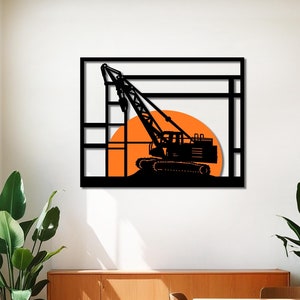 May include: Black metal wall art featuring a silhouette of a construction crane against a setting sun. The crane is framed by a geometric design.