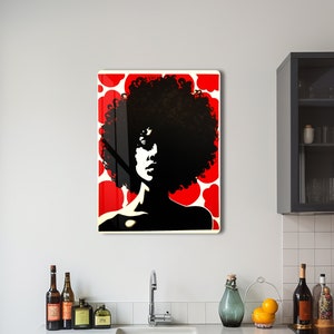 May include: A black and red wall art print featuring a silhouette of a person with a large afro. The background has a red and white polka dot pattern. The art is displayed in a kitchen setting.