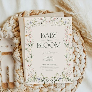 May include: A baby shower invitation with a floral border and the text "Baby in Bloom" and "Carrie Marshall".
