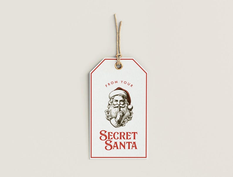 May include: White gift tag with a red border and a drawing of Santa Claus with his finger to his lips. The text "From your Secret Santa" is printed in red.