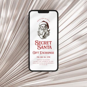 May include: A smartphone screen displaying a digital invitation for a Secret Santa gift exchange. The invitation features a cartoon image of Santa Claus with a finger to his lips, and the text "Secret Santa Gift Exchange" in red lettering. The event is scheduled for Friday, December 18th at 7pm, hosted by the Gilmores at Tex Holly Lane, Winterville, GA 14887. The invitation instructs guests to RSVP to Lola before December 1st at 123-456-7890.