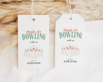 May include: Two white gift tags with a bowling theme. The tags have the text "thanks for bowling with me" and "XOXO ADRIANA". The tags are decorated with a drawing of bowling pins.