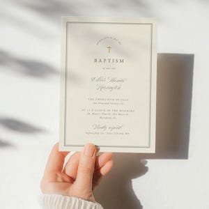 May include: Baptism invitation card with elegant script and a gold cross. The invitation includes the name Oliver Thomas Harrington, date, time, and location: St. Mary's Church, Hartford, CT. The card also requests a response before July 1st.