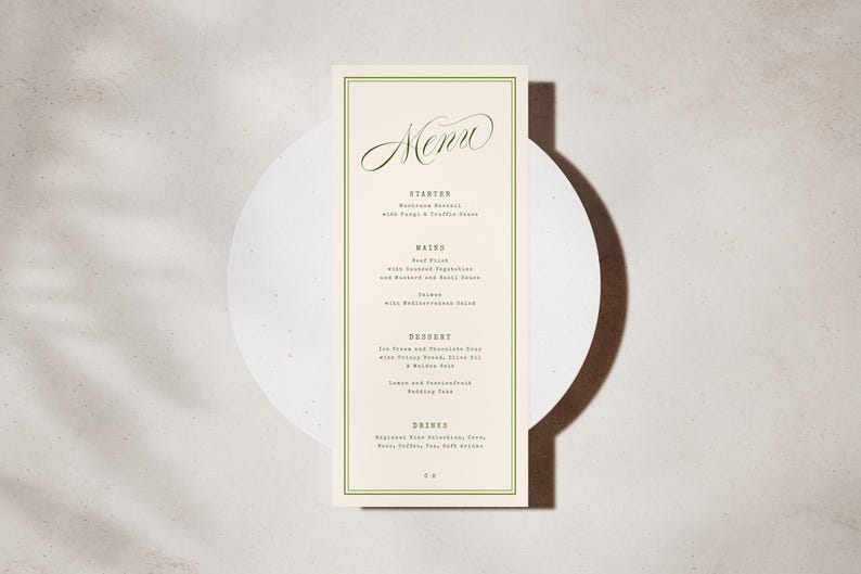 May include: A cream-coloured menu card with a green border, featuring the word "Menu" in cursive. The menu lists starters, mains, desserts, and drinks. The card is placed on a white circular surface. The background is a neutral tone.