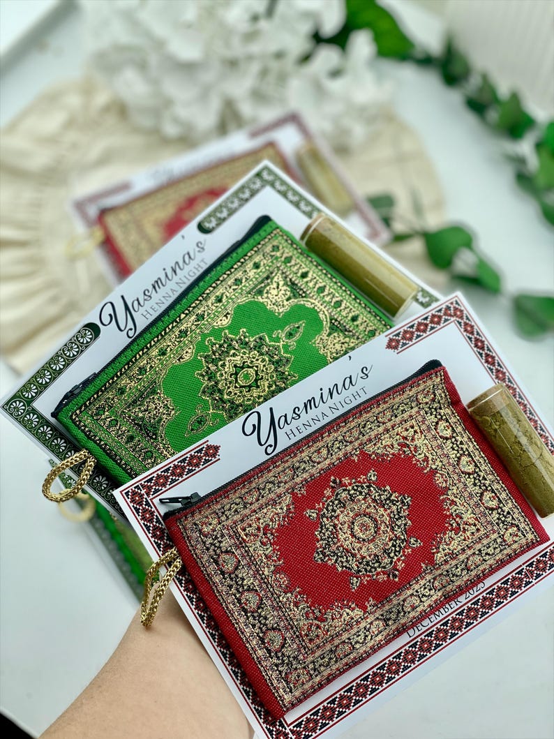 Three favor sets are shown, each with a mini wallet in green, red, or beige, a small tube of henna powder, and a personalized card reading "Yasmina's Henna Night."