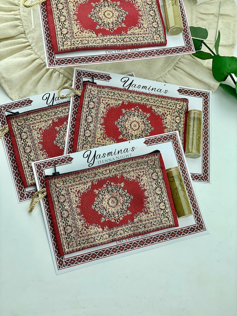 Four red patterned mini wallet favor sets are shown, each with a henna tube and a personalized card.