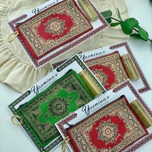 Five favor sets are arranged on a white surface, with mini wallets in red, green, and beige patterns, each with a henna tube and a personalized card.