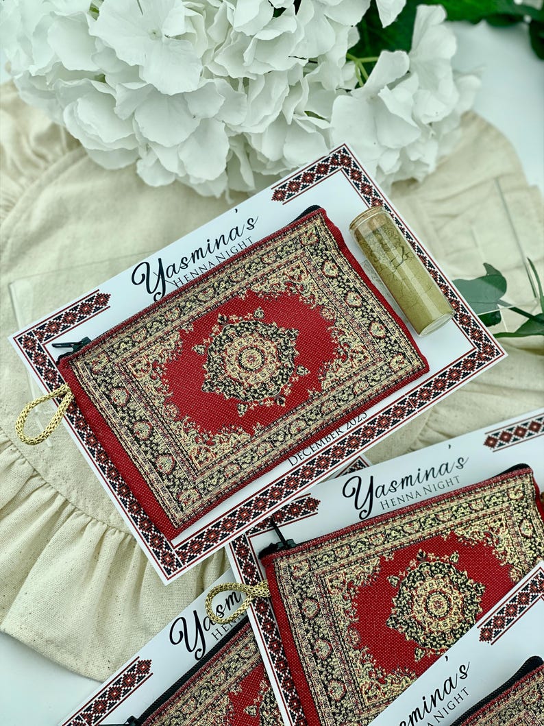 Four red patterned mini wallet favor sets are displayed, each with a henna tube and a personalized card.