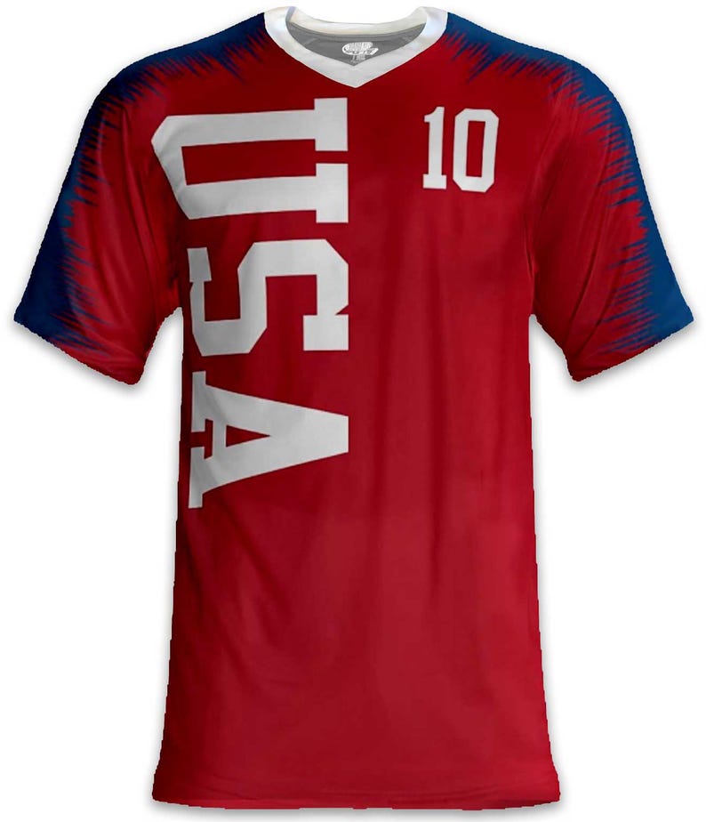 May include: Red V-neck jersey with the word "USA" in large white letters down the side and the number "10" on the upper right. The sleeves and shoulders have a blue and red design.