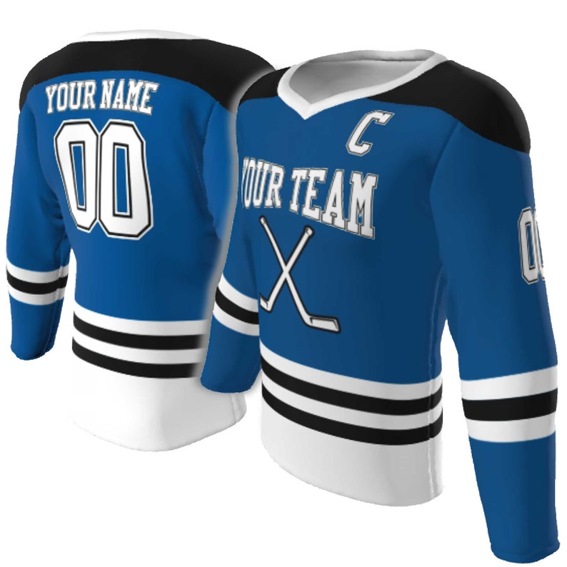 May include: A blue hockey jersey featuring black shoulder panels and white stripes on the sleeves and hem. The front displays the text YOUR TEAM, a letter C, and crossed hockey sticks. The back shows YOUR NAME and the number 00 in white.
