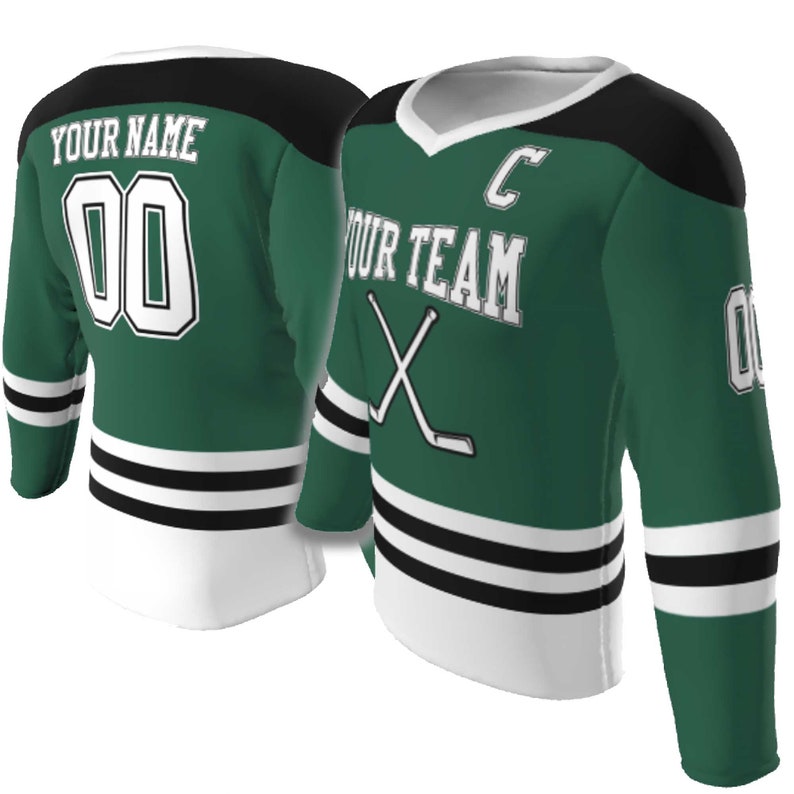May include: A green hockey jersey with black shoulders and white trim. The front features the text YOUR TEAM, a letter C, and crossed hockey sticks. The back displays YOUR NAME and the number 00. The sleeves have black and white stripes.