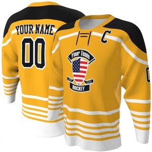 Gold body with black and white trim Lace up Neck Custom Hockey Jerseys - USA Shield Your Team Hockey Design, Multi stripe, Player Name and Numbers, Birds Eye Mesh, Sublimated