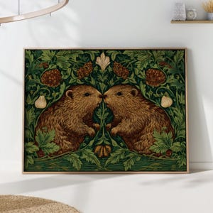 Op de afbeelding: Een ingelijste kunstdruk met twee bruine bevers die neus aan neus staan, tegen een achtergrond van groen gebladerte en decoratieve elementen. Het kunstwerk heeft een vintage esthetiek, met een gedetailleerde illustratiestijl en een houten lijst.